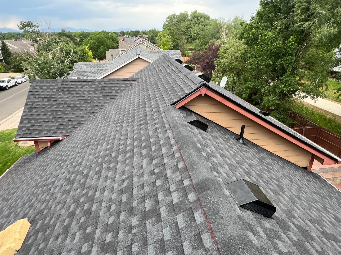 Pinnacle Home Restoration roofing crew selfie on flat roof in hi-vis vests Fort Collins Colorado