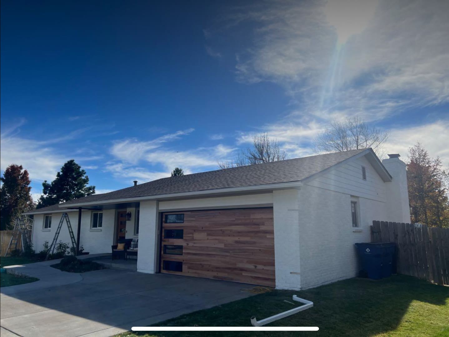 Brick ranch home after painting white with cedar garage door Fort Collins